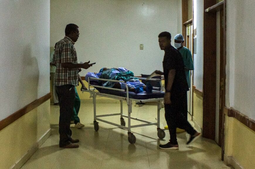 A patient is transported on a gurney at the Medani Heart Centre hospital in Wad Madani, the capital of the Al-Jazirah state in east-central Sudan, on May 25, 2023