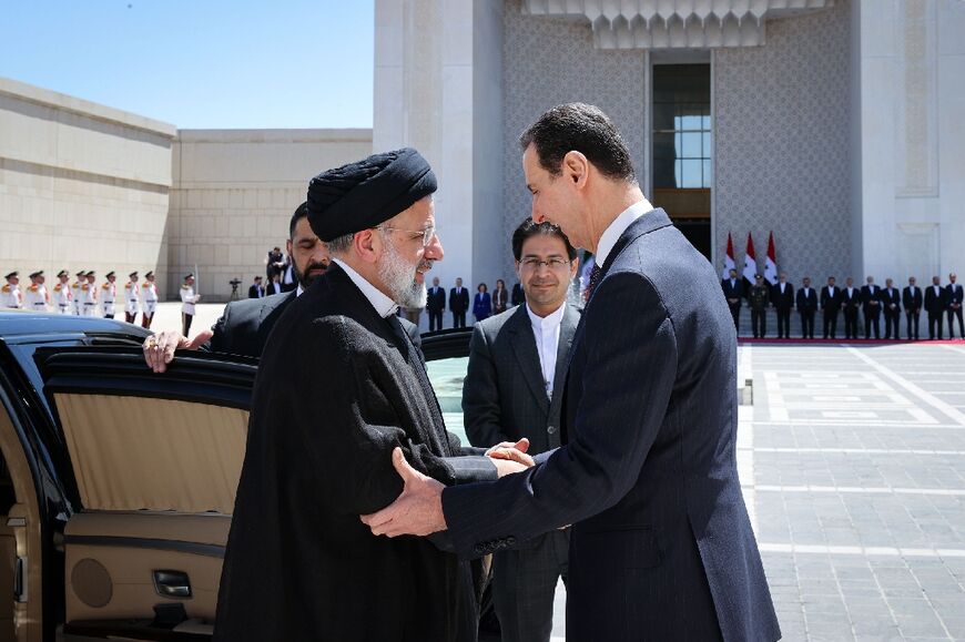 Syria's President Bashar al-Assad, on the right, received his Iranian counterpart Ebrahim Raisi at the presidential palace in Damascus on May 3, 2023