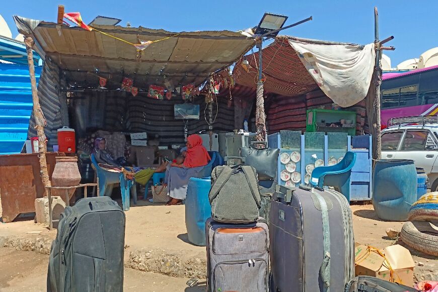 Refugees who fled war-torn Sudan wait in the shade at the Wadi Karkar bus station near the Egyptian city of Aswan