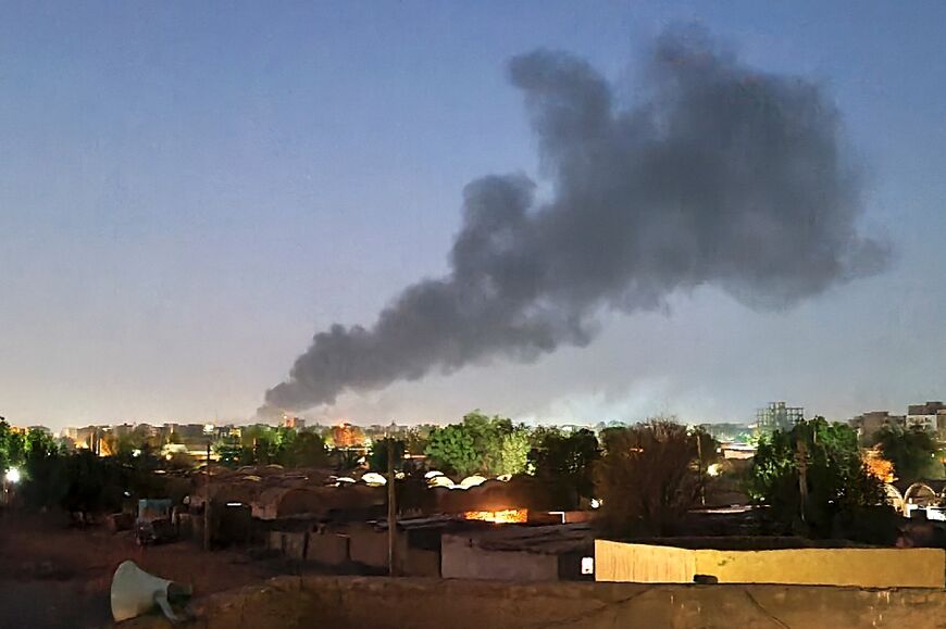 Smoke billows in Khartoum during ongoing fighting between the forces of two rival generals 