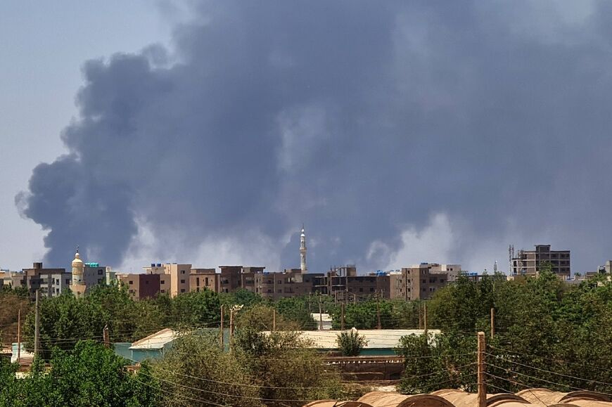 Smoke billows over buildings in Khartoum on May 1, 2023 as deadly clashes between rival generals' forces have entered their third week