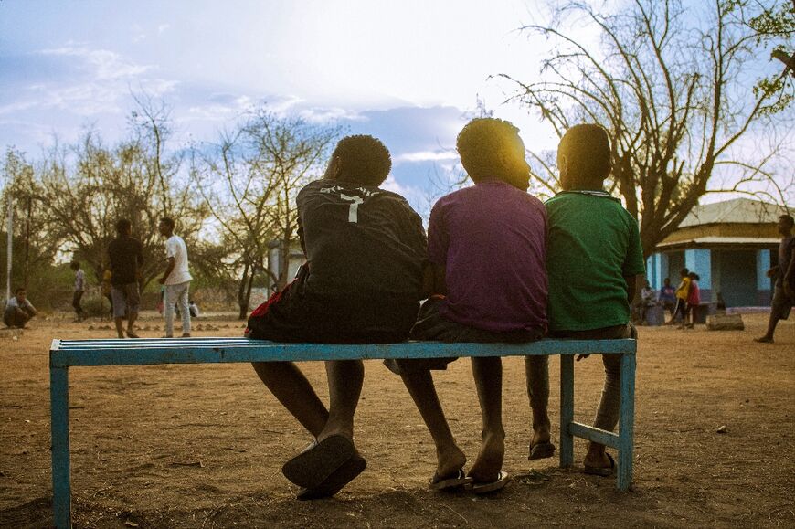 At a camp for internally displaced Sudanese in Wad Madani, southeast of Khartoum, children watch others play football