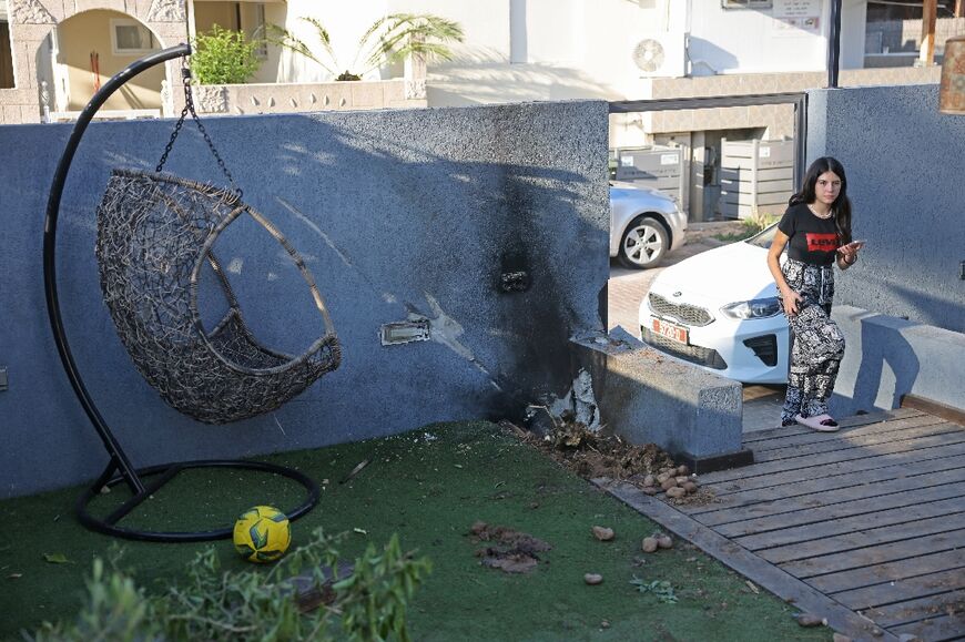 A youth looks at a damaged house in the southern city of Sderot following a flare-up between the Israeli military and Gaza militants