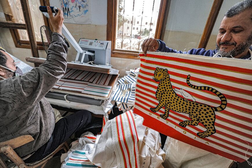 Painted cloths are pressed at the Malaika Linens factory in the 6th of October industrial zone southwest of Egypt's capital