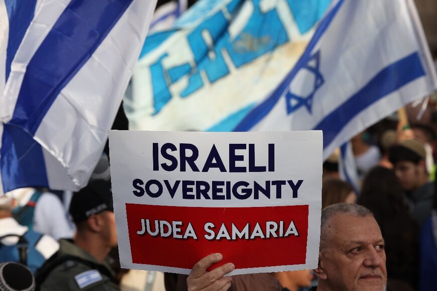 A placard held by the Jerusalem marchers demands Israel's annexation of the whole of the occupied West Bank, one of several causes on parade which are deeply provocative to the Palestinians