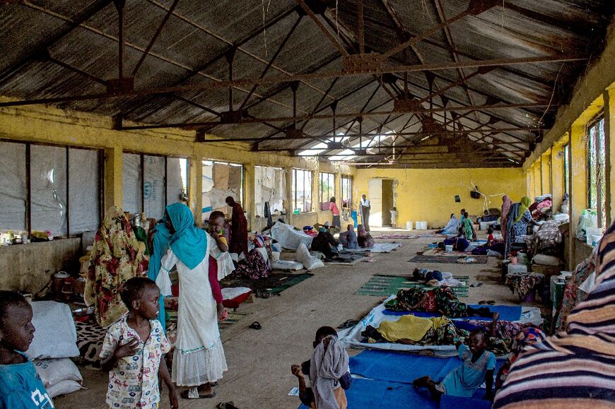 Sudanese women and children crowd into a camp for the displaced in Al-Suwar, about 15 kilometres (10 miles) north of Wad Madani