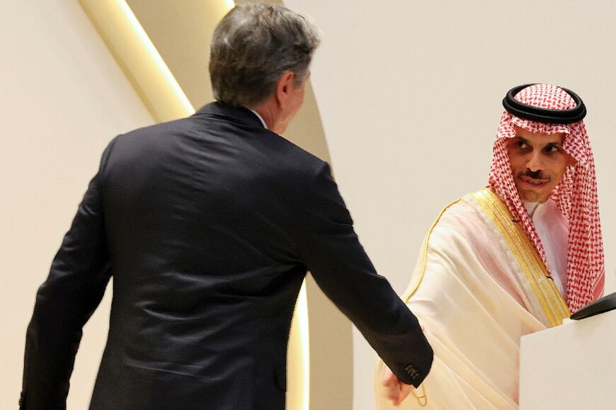 US Secretary of State Antony Blinken  approaches to shake the hand of Saudi Foreign Minister Faisal bin Farhan during a joint press conference in Riyadh 