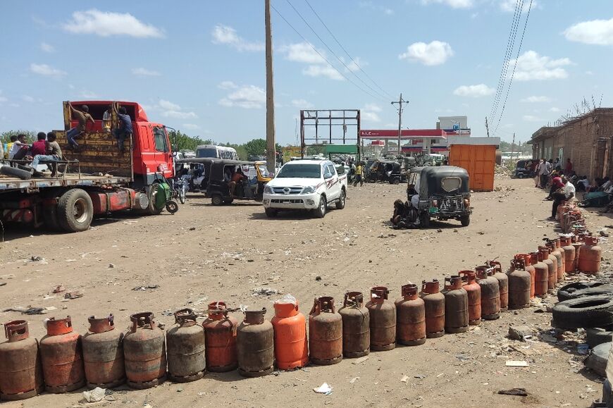 People wait for a new shipment of liquefied petroleum gas (LPG) cylinders in the Sudanese city of Gadaref