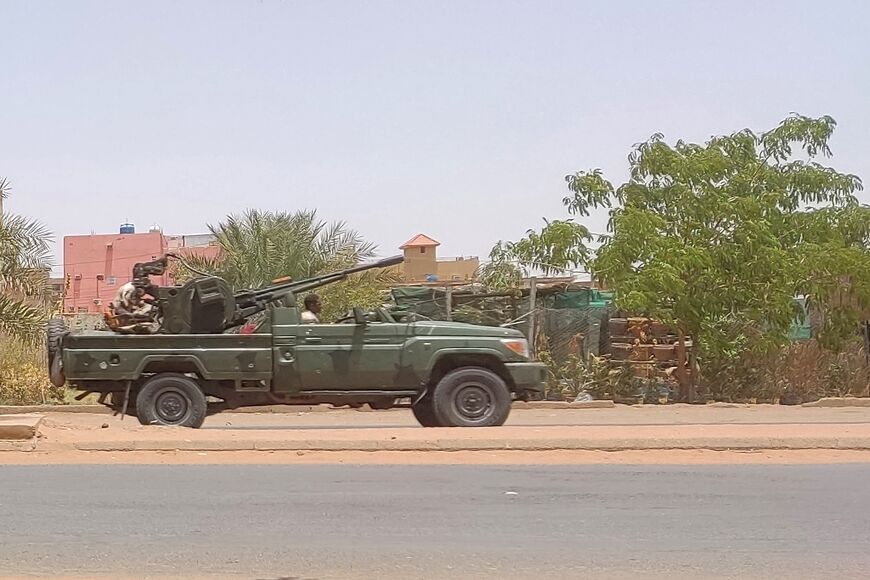 Fighters of the paramilitary Rapid Support Forces (RSF) drive an armoured vehicle in southern Khartoum, on May 25, 2023