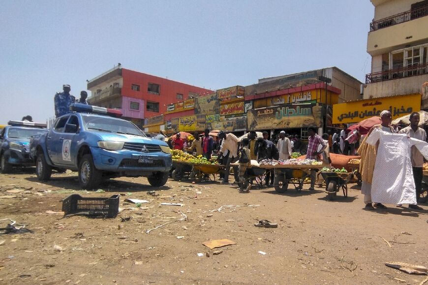 Sudanese police patrol the main market of Wad Madani, which hosts many people uprooted by the war