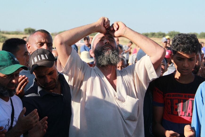 Tunisians mourn during the funeral of a man who was fatally stabbed during a scuffle between local residents and migrants from sub-Saharan Africa, in Sfax