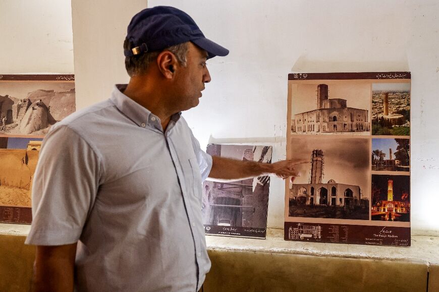 A cultural heritage specialist gives a briefing on the wind-catcher of Dowlat Abad Garden, the world's tallest 