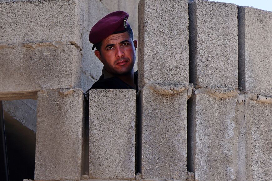 A Palestinian officer stands guard during the visit 