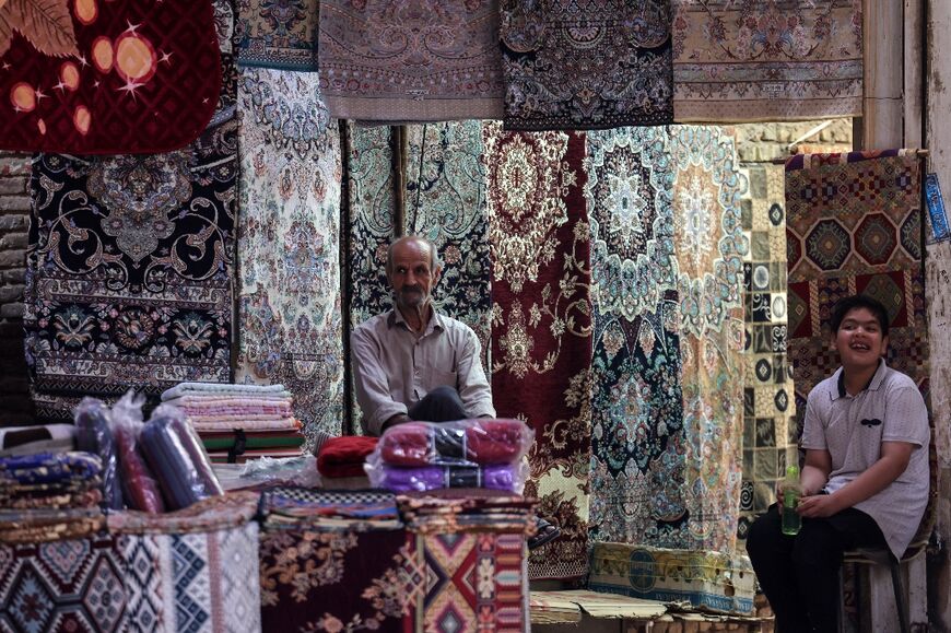 A rug vendor waits for customers in the old market of Iran's central city of Yazd 