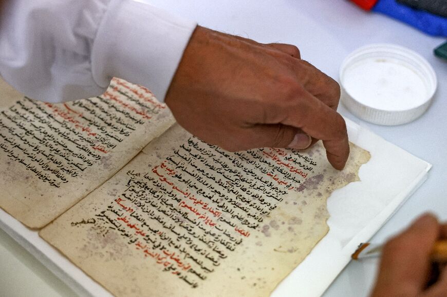 Restorer Rami Salameh works on a manuscript at a lab in the library