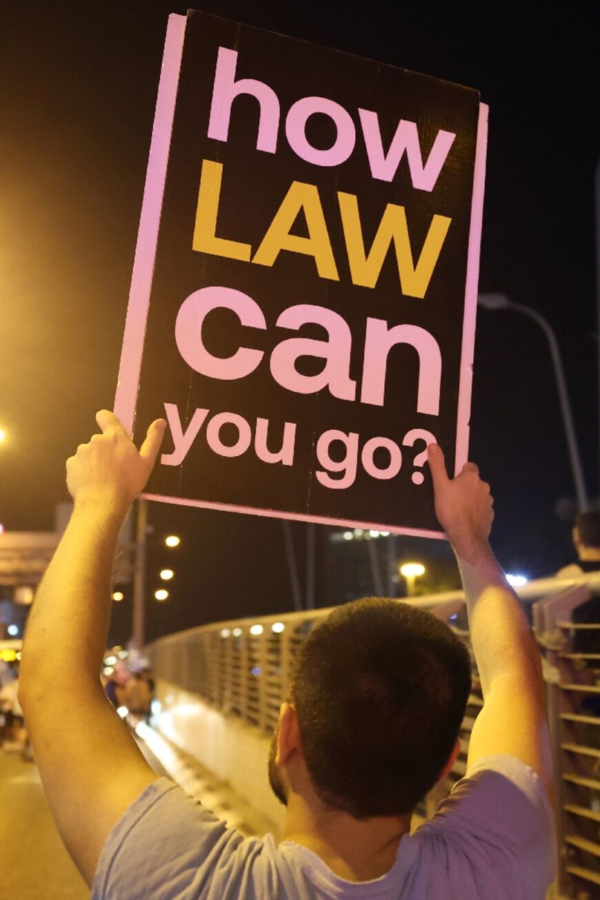 A placard-carrying protester in Tel Aviv