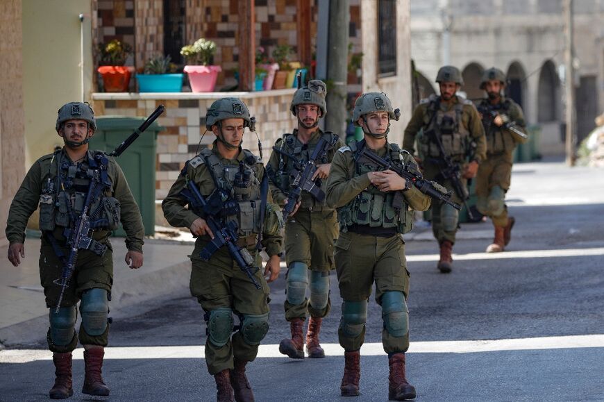 Israeli soldiers patrol the town of Ghajar in the annexed Golan Heights bordering Lebanon on July 6, 2023