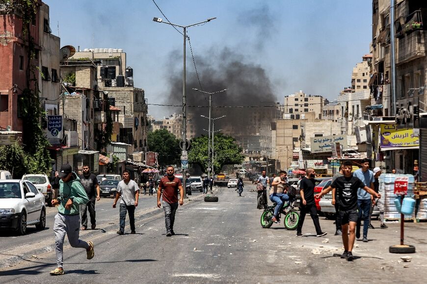 Smoke billows from burning tyres as Palestinians attempt to block Israeli troops' advance into Nablus's Al-Ain refugee camp 