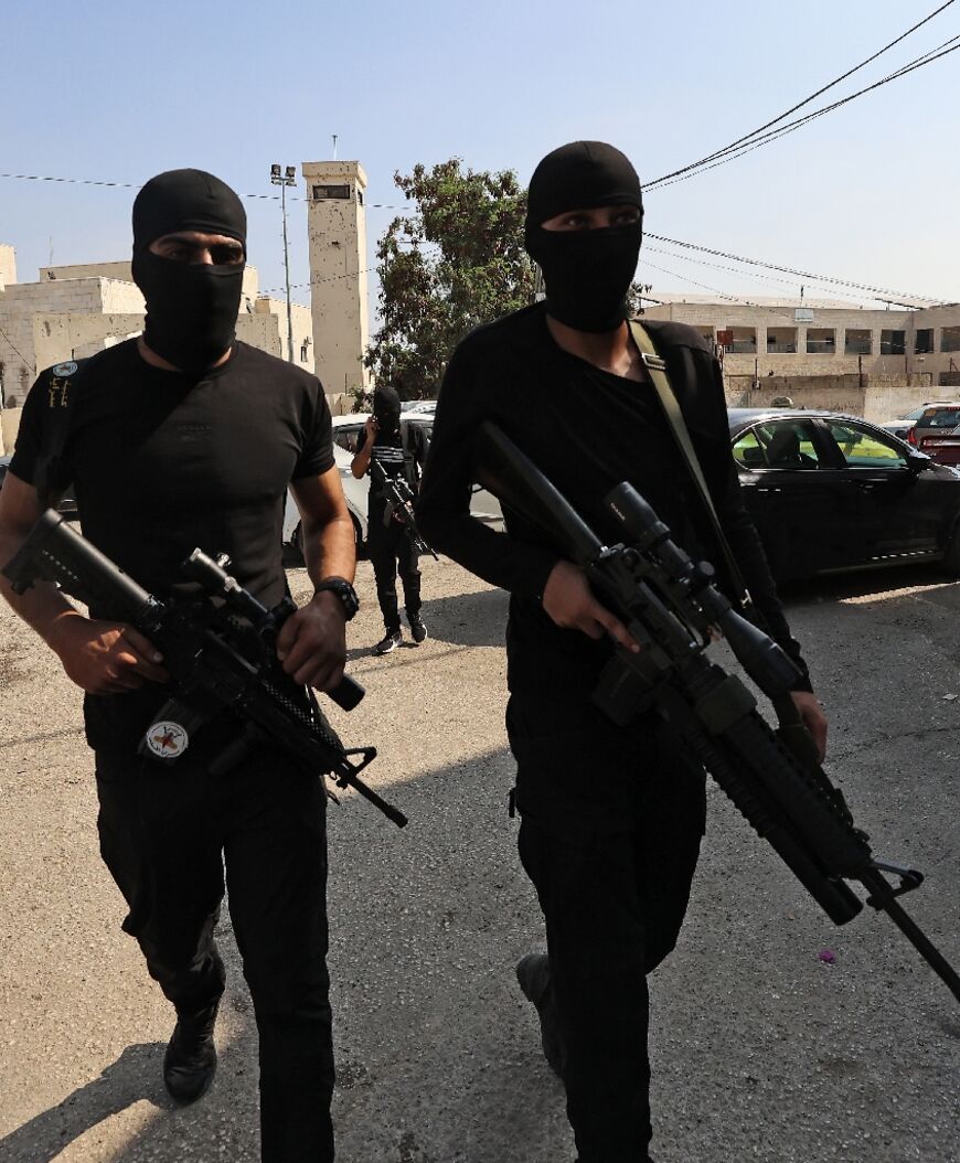 Armed Palestinian militants attend the funeral of Mustafa al-Kastouni