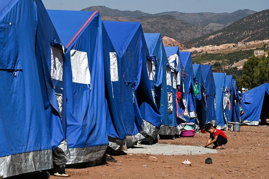 A child plays next to a village of tents sent up near a military field hospital in Asni