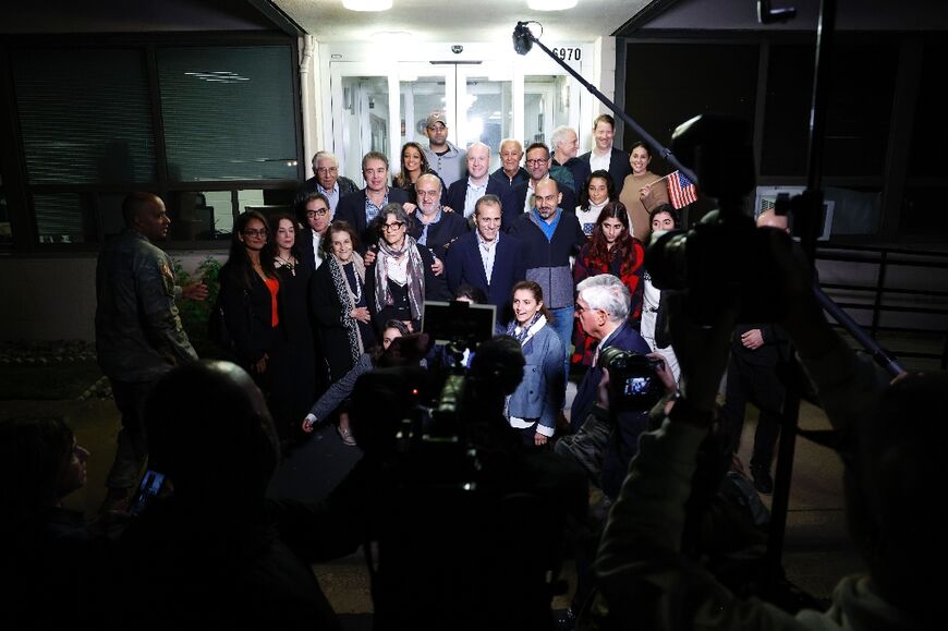 US officials arrange a group photo of the former prisoners freed by Iran landed at an airfield near Washington 