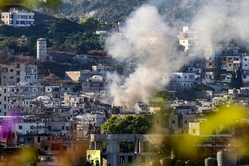 Smoke billows after a projectile hits near a centre of the Palestinian Fatah movement in the Ain al-Helweh camp for Palestinian refugees in Lebanon's southern coastal city of Sidon on September 10, 2023