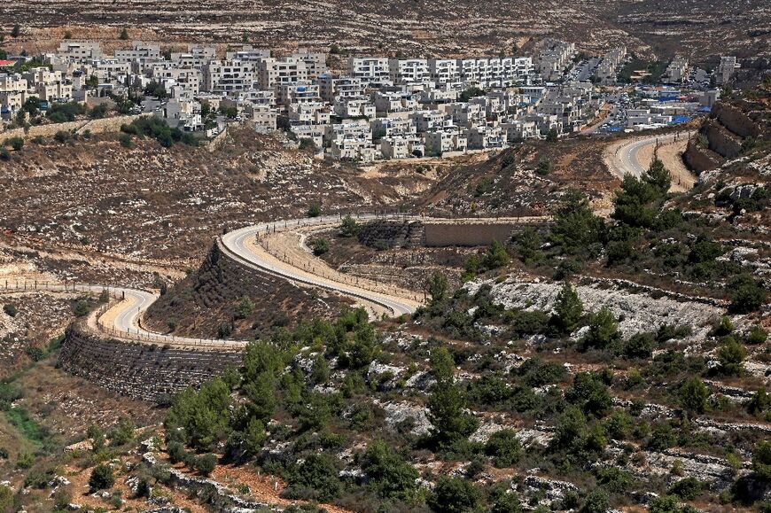 A serpentine road extends between the Jewish settlement of Givat Zeev and Palestinian villages near the Israeli-occupied West Bank city of Ramallah, on September 8, 2023