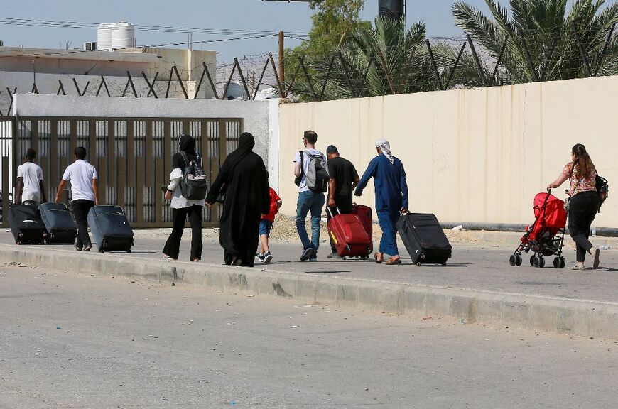 Passengers arrive on the Jordanian side of the King Hussein Bridge, also known as Allenby Bridge, between the West Bank and Jordan on July 19, 2022