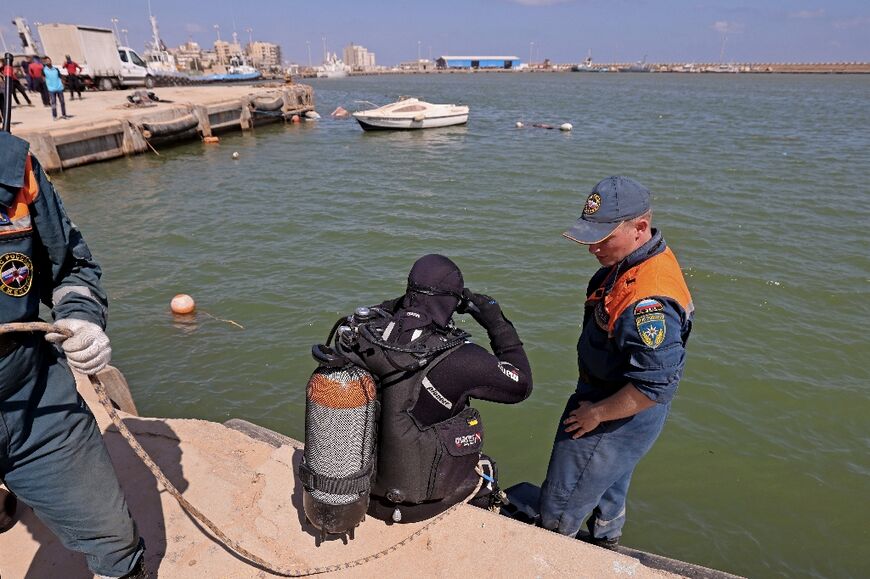 A member of the Russian rescue team prepares to dive in the sea to retrieve bodies in Libya's eastern port city of Derna 