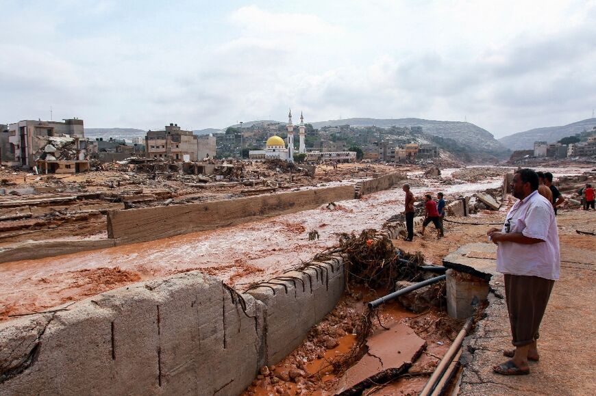 People look at the damage caused by freak floods in Derna, eastern Libya