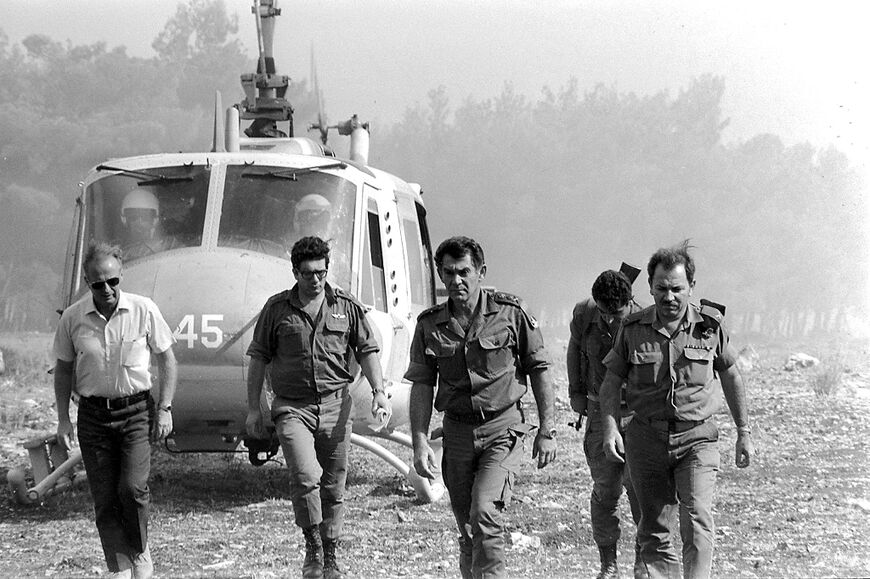 Israeli Chief of Staff David Elazar (2nd R) lands near frontline positions on the Golan Heights accompanied by future prime minister Yitzhak Rabin on October 9, 1973