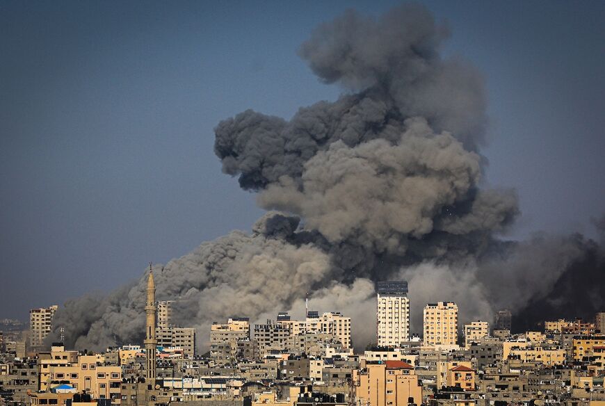 Smoke billows during Israeli air strikes in Gaza City on October 12