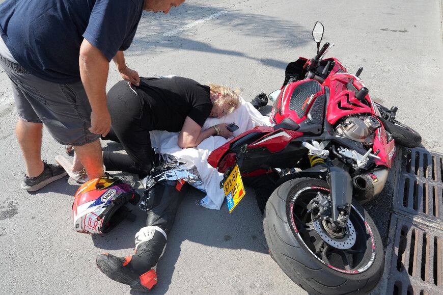 A woman weeps over the covered corpse of her nephew who was shot dead in the southern city of Sderot