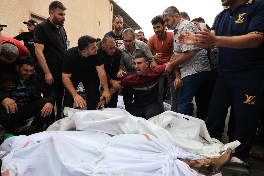 Palestinians mourn their relatives at a hospital after an Israeli airstrike on the refugee camp of Jabalia in the Gaza Strip on October 9, 2023