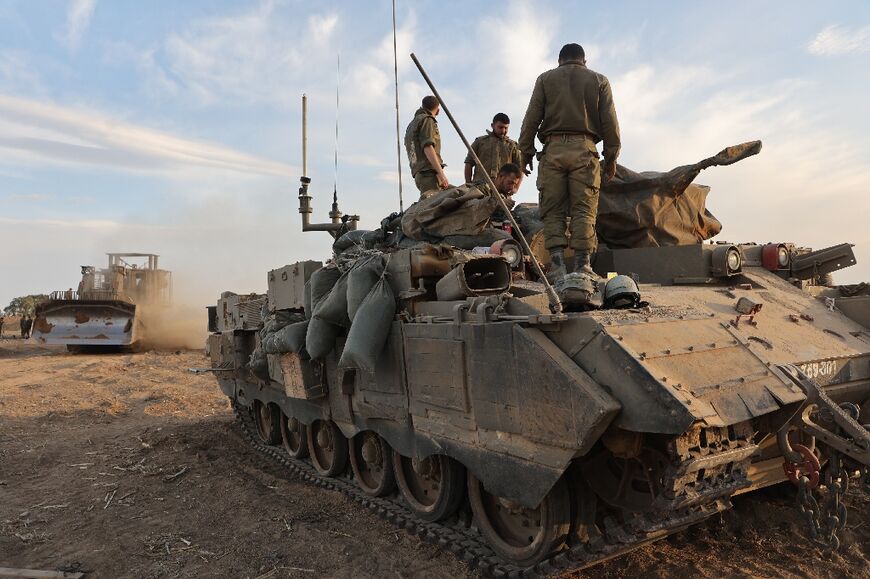 Israeli troops gather near the border with Gaza