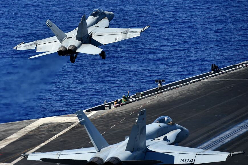 An F/A-18F Super Hornet takes off from the US navy's super carrier USS Dwight D. Eisenhower (CVN-69) ("Ike") in the Mediterranean Sea on July 7, 2016. The US aircraft carrier is deployed in support of Operation Inherent Resolve, maritime security operations and theater security cooperation efforts in the US 6th Fleet area of operations. Air Wings embarked aboard conducted strikes against the terrorist group ISIL in Libya, Iraq and Syria. / AFP / ALBERTO PIZZOLI (Photo credit should read ALBERTO PIZZOLI/AFP 