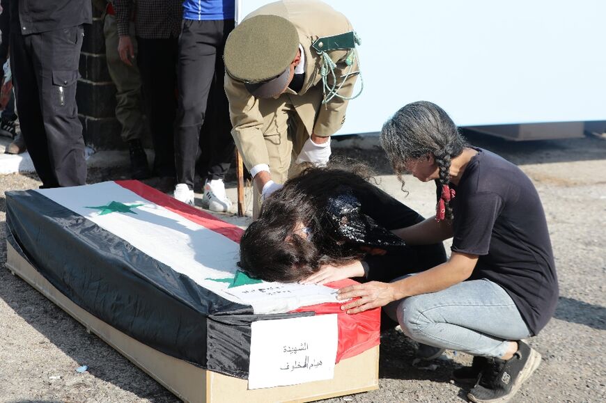 Relatives mourn during the funeral in government-held Homs 