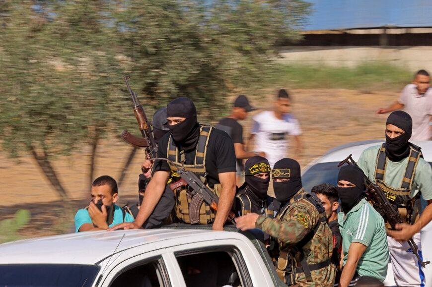 Palestinian militants move towards the border fence with Israel from Khan Yunis in the southern Gaza Strip