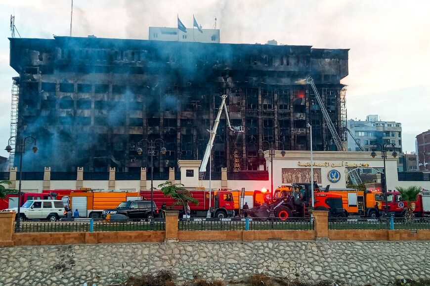 Firefighters try to extinguish the last flames in the morning