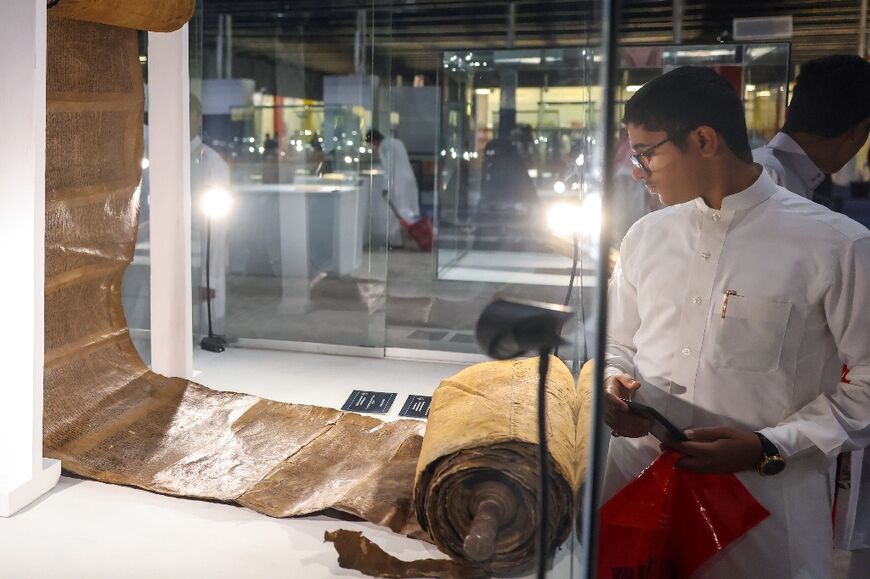 A man looks at a Torah scroll from the 16th century displayed at the Saudi International Book Fair in Riyadh on October 4, 2023