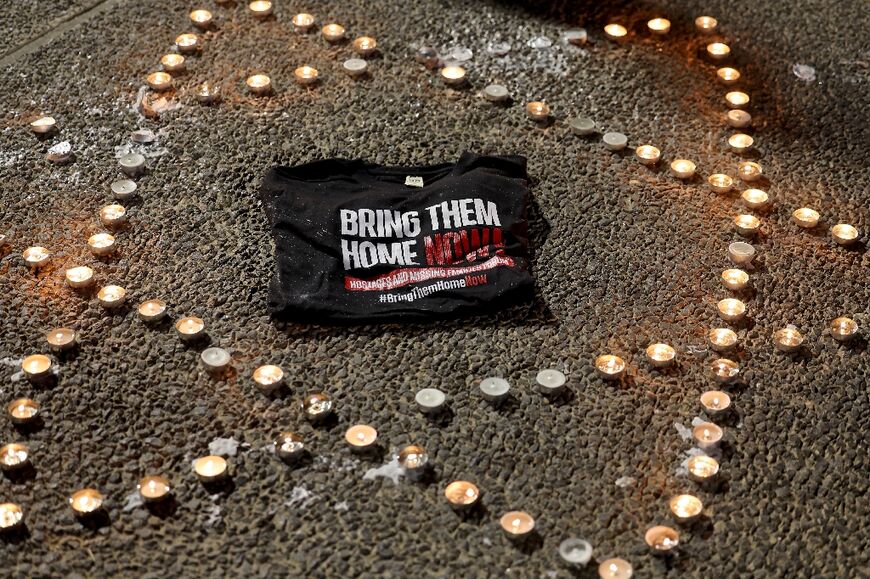 Candles arranged in a Star of David shape are lit at a gathering in Tel Aviv calling for the release of the hostages