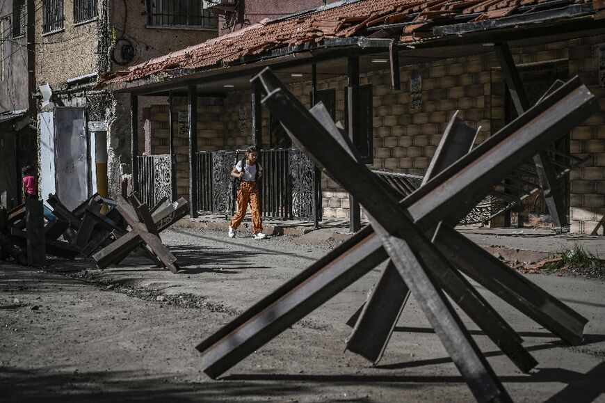 A girl passes a road block in the Jenin camp as violence surges in the occupied West Bank