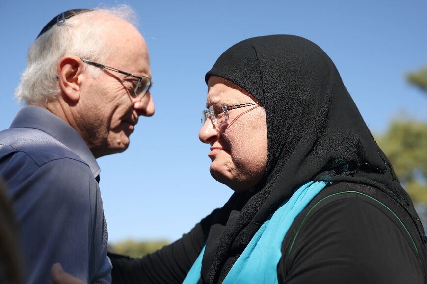 Vivian Silver's brother Nir greets Arab-Israeli peace activist Ghadir Hani at the memorial