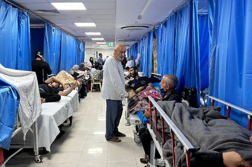 Patients and internally displaced line the halls at Al-Shifa hospital in Gaza City 