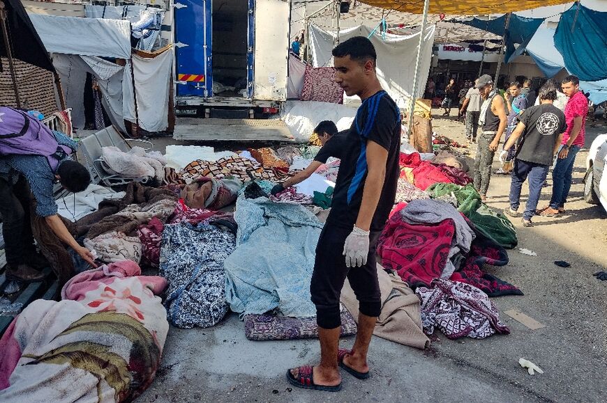 Men check the bodies brought to a Gaza hospital