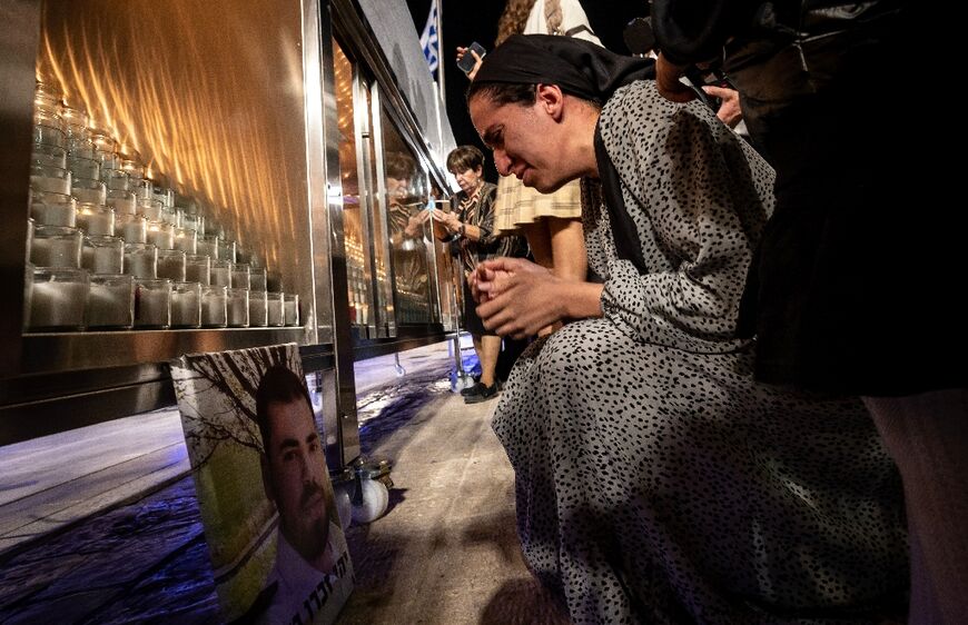 Families of the victims of the October 7 Hamas attack light candles at the Western Wall in Jerusalem to mark a month of mourning