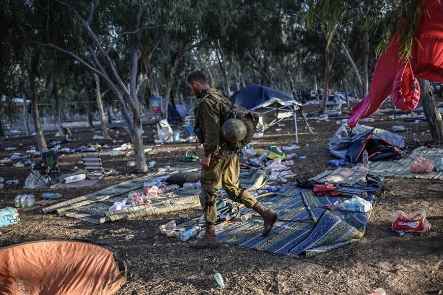 An Israeli soldier patrols in southern Israel on October 12, 2023, close to the place where 270 revellers were killed by militants during the Supernova music festival 