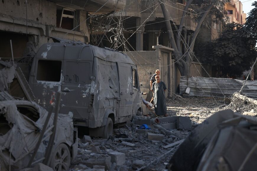 People inspect the damage at the Nuseirat refugee camp in central Gaza on November 17