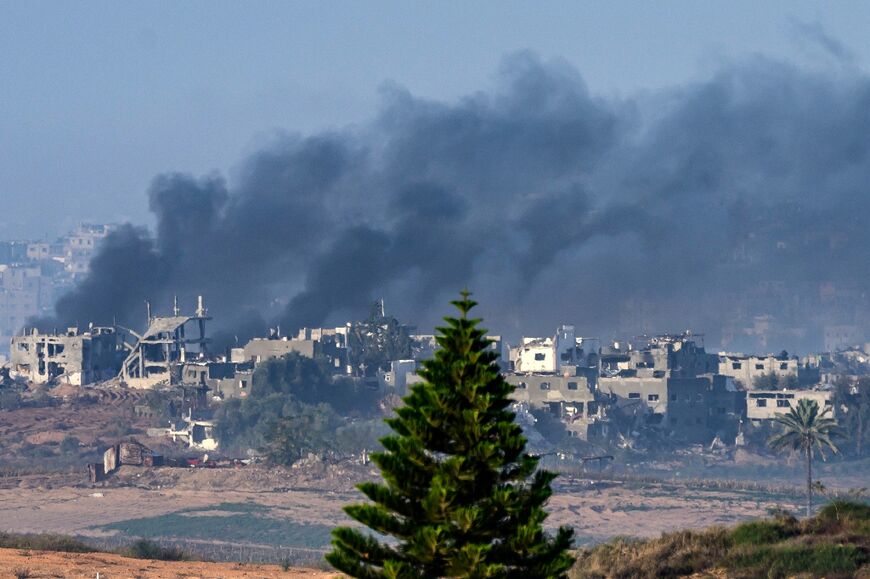 Seen from southern Israel, smoke rises from buildings still smouldering after being hit by Israeli strikes before the four-day truce began