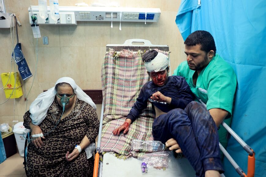 A nurse moves an an injured Palestinian boy in the the Al-Aqsa Hospital 